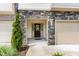 Close-up of the home's entrance, featuring a stone facade, black front door, and one-car garage at 3015 Cypress Lagoon Ct, Durham, NC 27703