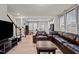 Open-concept living area with a sectional sofa, dining area, and a staircase leading to the second floor at 3015 Cypress Lagoon Ct, Durham, NC 27703