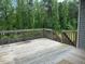A wood back deck with wooden railing and view to trees at 305 Theys Mill, Fuquay Varina, NC 27526