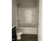 Clean bathroom featuring a shower-tub combo with a white surround and dark vanity at 305 Theys Mill, Fuquay Varina, NC 27526