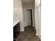 Well-lit bathroom featuring a dark vanity with a light countertop, a mirror, and a shower with glass doors at 305 Theys Mill, Fuquay Varina, NC 27526