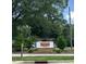 Theys Mill community sign surrounded by greenery and landscaping at 305 Theys Mill, Fuquay Varina, NC 27526