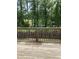 View of a wood deck with a railing, overlooking a fenced backyard and green foliage at 305 Theys Mill, Fuquay Varina, NC 27526