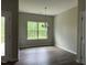 Bright dining area with wood floors and a large window offering natural light at 305 Theys Mill, Fuquay Varina, NC 27526