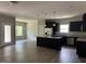 Open-concept kitchen with a center island, stainless steel appliances, and dark cabinetry at 305 Theys Mill, Fuquay Varina, NC 27526