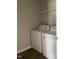 Functional laundry room with white appliances, a wire shelf, and tiled flooring at 305 Theys Mill, Fuquay Varina, NC 27526