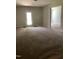 Open living area with carpeted floors and ample natural light at 305 Theys Mill, Fuquay Varina, NC 27526