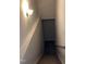 Staircase featuring carpeted steps, a white handrail, and a wall-mounted light fixture at 305 Theys Mill, Fuquay Varina, NC 27526