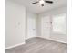 Bedroom featuring neutral paint, modern ceiling fan, and multiple white doors at 308 Caswell St, Burlington, NC 27217