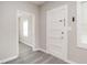 Entryway featuring a view into another room of the home with white doors and fresh gray paint at 308 Caswell St, Burlington, NC 27217
