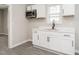 Kitchen with white cabinets, modern appliances, and a window above the sink at 308 Caswell St, Burlington, NC 27217