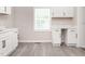Bright kitchen featuring white cabinets, modern appliances and gray vinyl floors at 308 Caswell St, Burlington, NC 27217