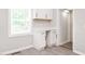 Bright kitchen featuring white cabinets, modern appliances and gray vinyl floors at 308 Caswell St, Burlington, NC 27217