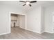 Open-concept living room with light gray walls and modern flooring, flowing into the kitchen at 308 Caswell St, Burlington, NC 27217