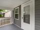 View of the covered porch and exterior of the home with gray siding at 308 Caswell St, Burlington, NC 27217