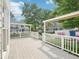 Backyard featuring a deck with white railings, offering a view of neighboring homes at 3303 Glen Currin Dr, Raleigh, NC 27612