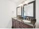 Bathroom featuring a dark wood double vanity with black countertop at 3303 Glen Currin Dr, Raleigh, NC 27612
