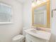 Bright bathroom featuring a white vanity, framed mirror and bathtub with shower at 3303 Glen Currin Dr, Raleigh, NC 27612