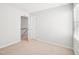 Bedroom featuring neutral carpet, white walls, and access to the hallway and closet at 3303 Glen Currin Dr, Raleigh, NC 27612