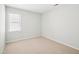 Neutral-carpeted bedroom with white walls and a window with blinds at 3303 Glen Currin Dr, Raleigh, NC 27612
