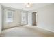 Bright bedroom features neutral carpet, two windows, and an ensuite bathroom at 3303 Glen Currin Dr, Raleigh, NC 27612