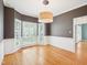 Formal dining room with bay windows and modern light fixture at 3303 Glen Currin Dr, Raleigh, NC 27612