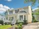 View of home with covered front porch, mature landscaping and visible driveway at 3303 Glen Currin Dr, Raleigh, NC 27612