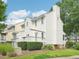 View of the back of the house with white siding, a deck, and a green lawn at 3303 Glen Currin Dr, Raleigh, NC 27612