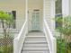 Front porch features stairs leading to front door, trimmed shrubs and plants at 3303 Glen Currin Dr, Raleigh, NC 27612