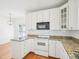 Charming kitchen features granite countertops, white cabinetry, and stainless steel appliances at 3303 Glen Currin Dr, Raleigh, NC 27612