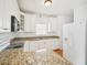 Bright kitchen features white cabinetry and appliances, with a breakfast bar area at 3303 Glen Currin Dr, Raleigh, NC 27612