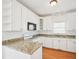Bright kitchen features subway tile backsplash, granite countertops, and white cabinetry at 3303 Glen Currin Dr, Raleigh, NC 27612