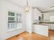 View of the kitchen nook with hardwood floors, granite countertops, and natural light at 3303 Glen Currin Dr, Raleigh, NC 27612