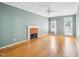 Features of the living room include hardwood floors, brick fireplace, ceiling fan and natural light at 3303 Glen Currin Dr, Raleigh, NC 27612