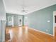 Living room boasts hardwood flooring, fireplace, and a ceiling fan at 3303 Glen Currin Dr, Raleigh, NC 27612