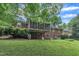 Exterior view of a brick home with a screened-in porch and well-kept lawn at 3304 Redbud Ln, Raleigh, NC 27607