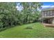 Large backyard with a garden bed and a view of the screened-in porch at 3304 Redbud Ln, Raleigh, NC 27607