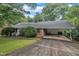 Brick ranch-style home with an asphalt driveway and covered carport at 3304 Redbud Ln, Raleigh, NC 27607