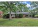 Inviting brick home with an attached carport and well-maintained front lawn at 3304 Redbud Ln, Raleigh, NC 27607