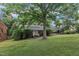 Beautiful brick home with a welcoming front yard and mature shade trees at 3304 Redbud Ln, Raleigh, NC 27607