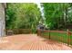 Wooden back deck with railing overlooking a lush, green backyard at 3330 Nantuckett Ave, Durham, NC 27703