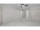 Bedroom with neutral carpet and walls featuring a ceiling fan and closet doors at 3330 Nantuckett Ave, Durham, NC 27703
