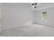 Spacious bedroom with neutral carpet, ceiling fan, and a window providing natural light at 3330 Nantuckett Ave, Durham, NC 27703