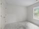 Bedroom with neutral carpet and walls featuring a window and closet doors at 3330 Nantuckett Ave, Durham, NC 27703