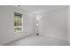 Bright bedroom featuring neutral carpet, natural light from a large window, and a floor lamp at 3330 Nantuckett Ave, Durham, NC 27703