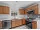 Well-lit kitchen with stainless steel appliances, oak cabinetry, and a view of the backyard at 3330 Nantuckett Ave, Durham, NC 27703