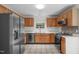 Traditional kitchen with stainless steel appliances, oak cabinets, and tile flooring at 3330 Nantuckett Ave, Durham, NC 27703