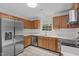 Clean kitchen with stainless steel appliances, light oak cabinets, and tile flooring at 3330 Nantuckett Ave, Durham, NC 27703