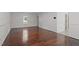 Empty living room with hardwood floors, lots of natural light, and neutral decor at 3330 Nantuckett Ave, Durham, NC 27703