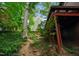 Backyard featuring stone steps, natural landscaping, and treelined views at 3416 Ocotea St, Raleigh, NC 27607
